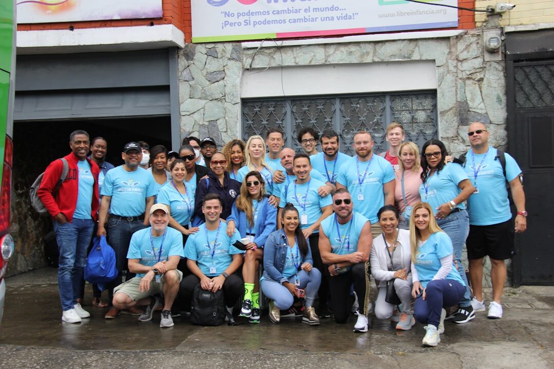 Team of volunteers and seniors standing together in front of a community center