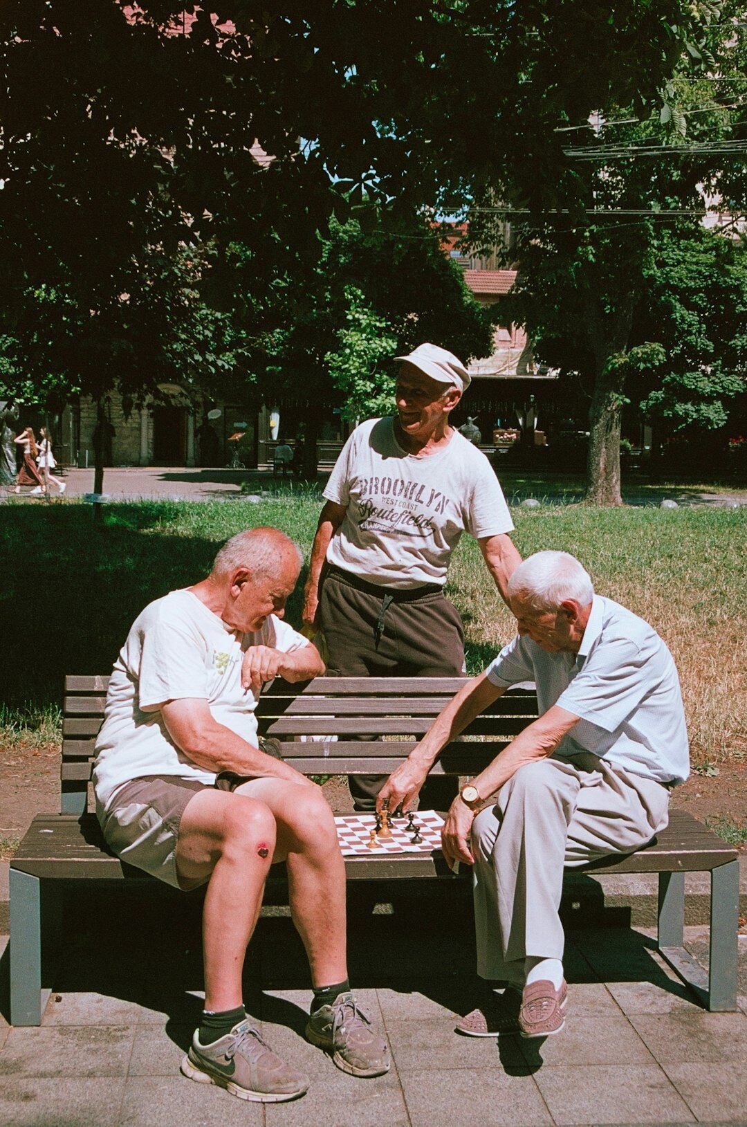 senior friends chatting in park