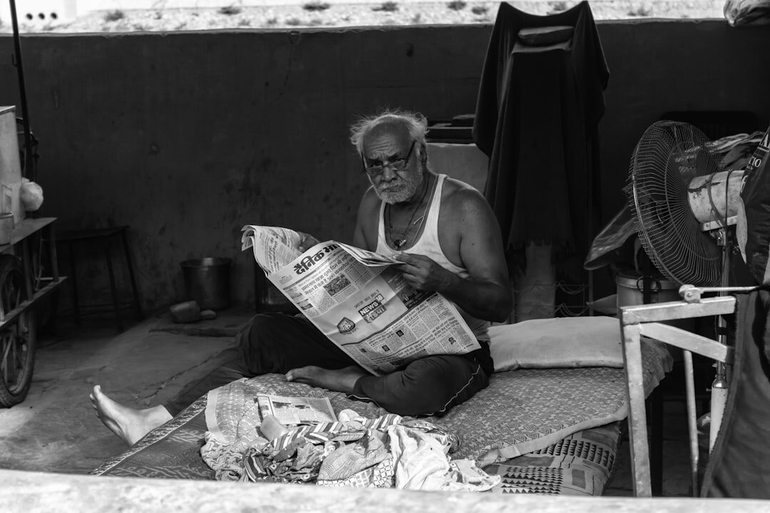 elderly people reading newspaper