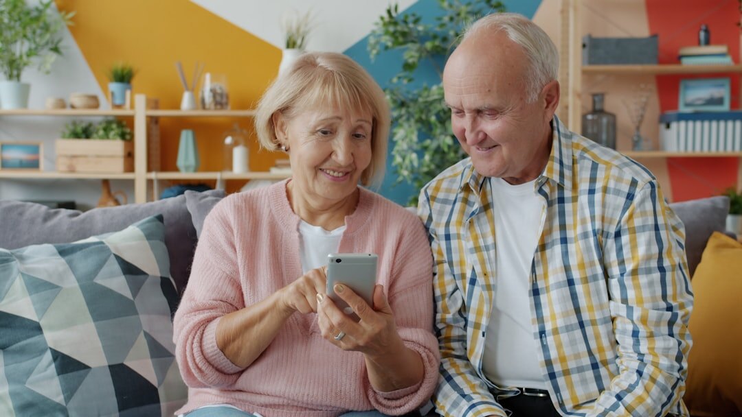 Happy senior couple reviewing a membership card and documents at home
