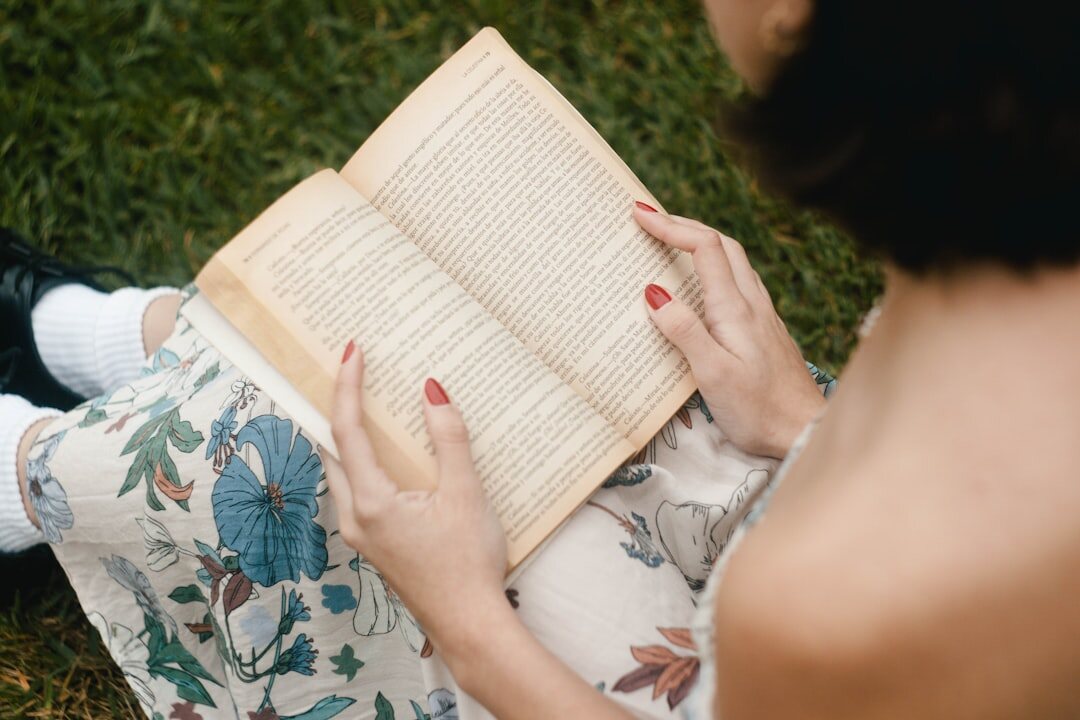 senior reading book in garden