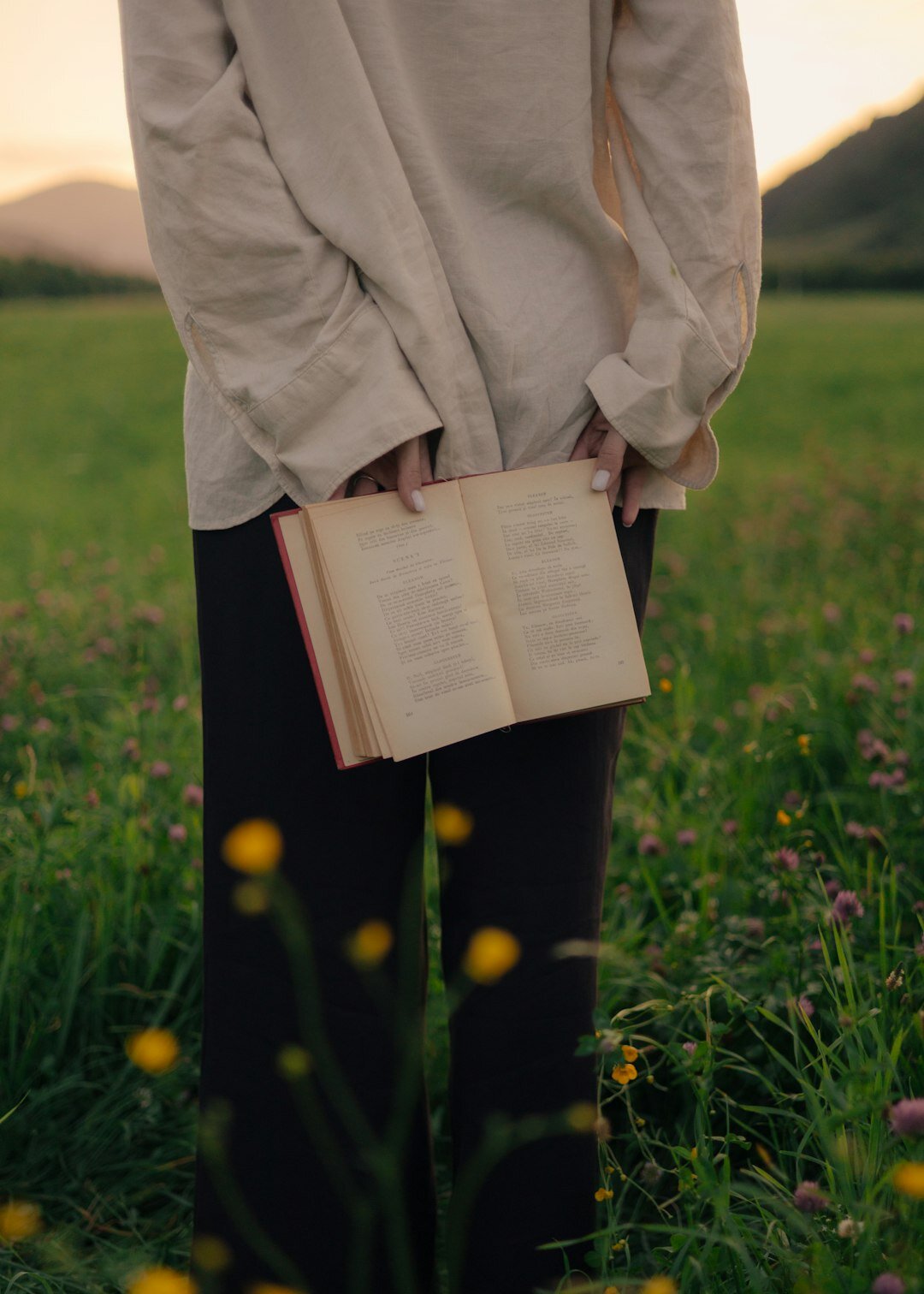 senior holding book outdoors