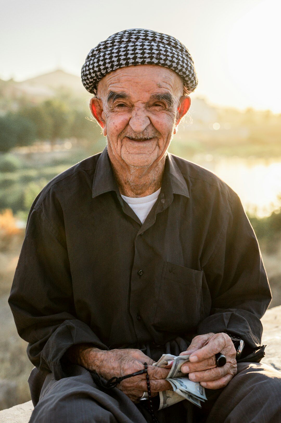 senior person with savings jar